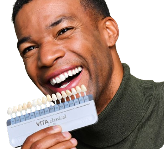 Patient with dental shade guide for veneers